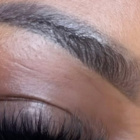 Healed brow shown close up almost two years after the last touch-up, powder fill soft and the tail still defined